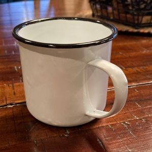 White enamel tin cup with black rim